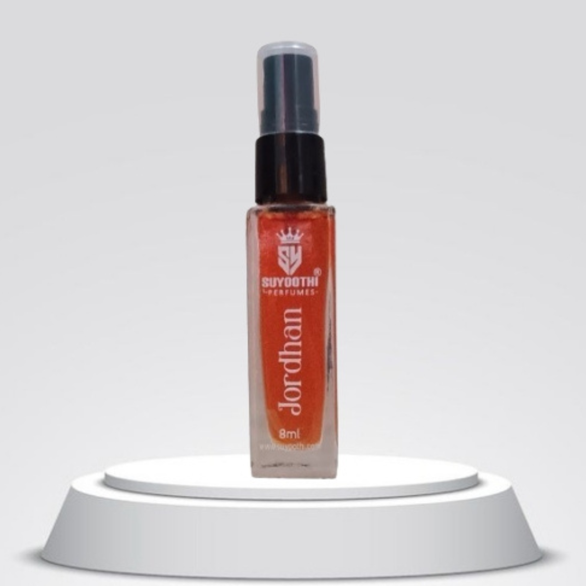 A 8ml spray bottle of Suydothi Perfumes 'Jordhan' fragrance, featuring a clear glass bottle filled with amber-orange liquid, a black spray nozzle, and a white label, displayed on a white circular pedestal against a light gray background.